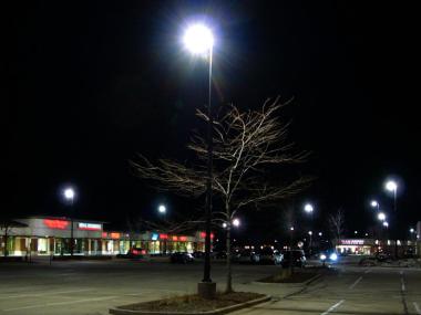 Parking lot with IESNA cutoff light fixtures, illustrating glare.