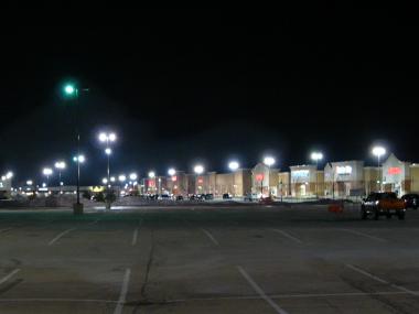 Mall parking lot with unshielded light fixtures.