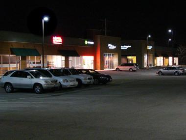 Parking lot with fully shielded light fixtures on poles.
